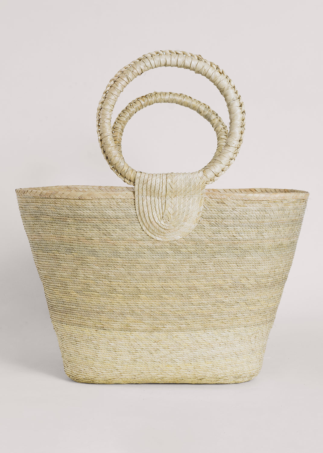 Rosita Palm Straw Tote: Hand-woven, light palm fiber tote bag with circular handles.
