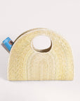 Light palm straw half-circle Concha Palm Tote with a circular handle and magazine.