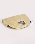 Light palm straw half-circle tote, hand-woven from natural palm fiber with inner magnet closure.